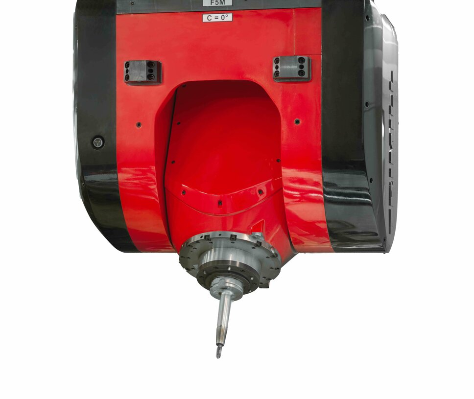 A precise mechanical machining unit in the tool manufacturing industry. The image shows the head of a state-of-the-art milling machine with a robust tool holder. The machine features a red and black casing and is designed to process workpieces with the highest precision. This is a typical example of advanced mechanical machining in tool manufacturing, particularly for the automotive industry.